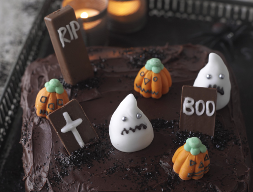 Graveyard Cake with pumpkins and ghosts made from icing